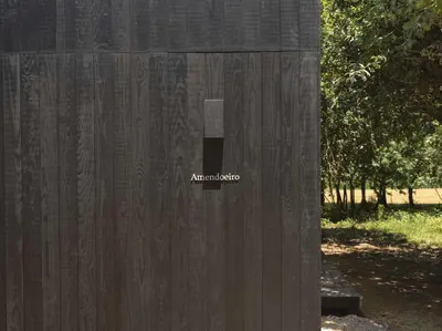 a wooden fence with the word amaranto on it at A Leira 116 Cabañas de diseño in Sarria