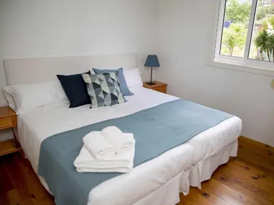 a bedroom with a large bed with towels on it at A Casiña - Casa Rural en la Ribeira Sacra, Galicia in Ourense