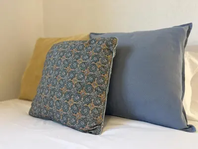 a pillow sitting on top of a bed at A Casiña - Casa Rural en la Ribeira Sacra, Galicia in Ourense