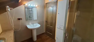 a bathroom with a sink and a mirror and a shower at Casa Buda Conors & Spa Boutique in Foz