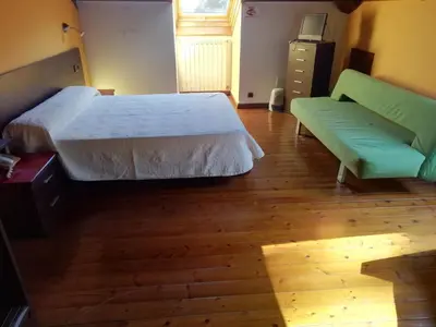 a bedroom with a bed and a green couch at Casa Buda Conors & Spa Boutique in Foz