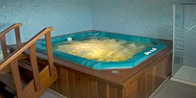 a hot tub in a corner of a bathroom at Casa Buda Conors & Spa Boutique in Foz