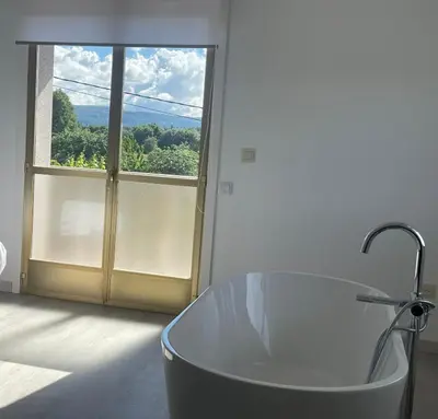 a bath tub in a bathroom with a large window at LA RATONERA in Podentes