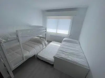 a bedroom with two bunk beds and a window at LA RATONERA in Podentes