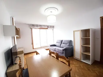 a living room with a table and a couch at Ría de Viveiro in Vivero