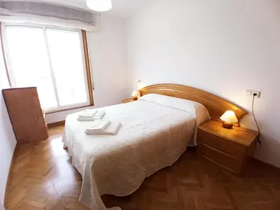 a bedroom with a large bed and a window at Ría de Viveiro in Vivero