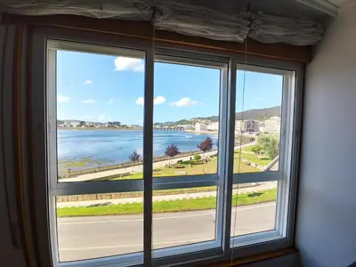 a window with a view of the water at Ría de Viveiro in Vivero