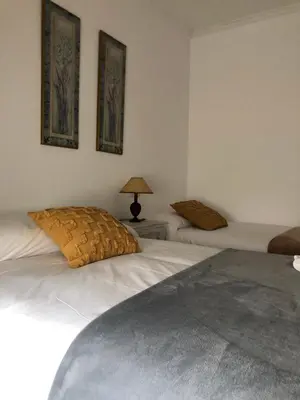a bedroom with two beds and a lamp on a table at FIFA in Arzúa