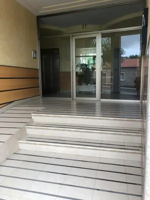 an empty building with glass doors and stairs at FIFA in Arzúa