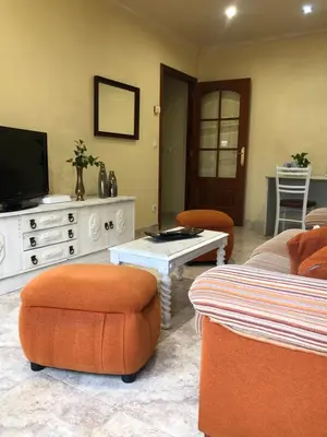 a living room with a tv and a couch and chairs at FIFA in Arzúa
