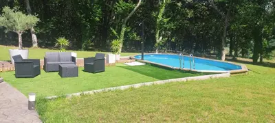 a group of chairs and a swimming pool at A Casa do Souto, Santiago de Compostela in Sigüeiro
