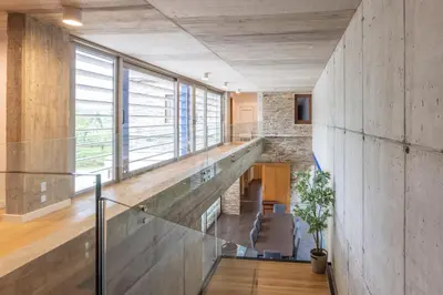a staircase in a house with a stone wall at A Casa do Souto, Santiago de Compostela in Sigüeiro