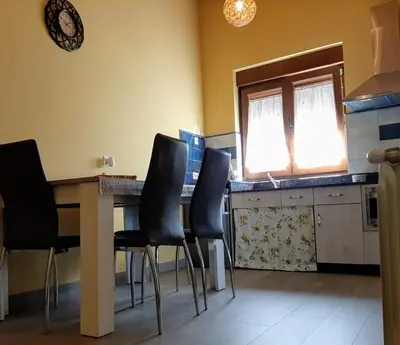 a kitchen with a table and chairs and a window at Vivienda Turistica in Coto