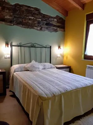 a bedroom with a large bed in a room at Vivienda Turistica in Coto