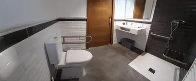 a bathroom with a toilet and a sink at Vivienda Turistica in Coto