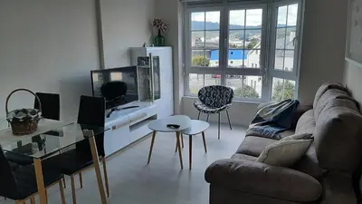 a living room with a couch and a table at Vial Sol in Viveiro
