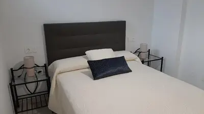 a bedroom with a large bed with a black headboard at Vial Sol in Viveiro