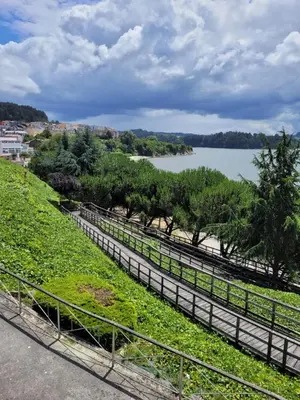 a fence with a view of a lake at PIso de 3 habitaciones en centro de Miño in Miño