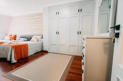 a bedroom with a bed with an orange blanket at PENSIÓN CALDEA in Caldas de Reis