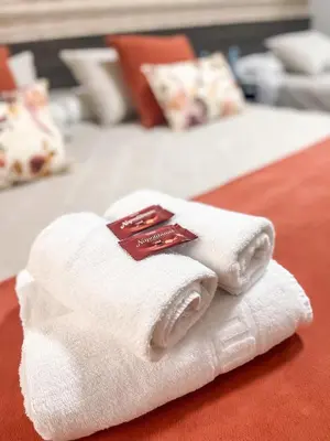 a pile of towels sitting on top of a bed at PENSIÓN CALDEA in Caldas de Reis
