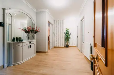 a hallway with white walls and a wooden floor at PENSIÓN CALDEA in Caldas de Reis