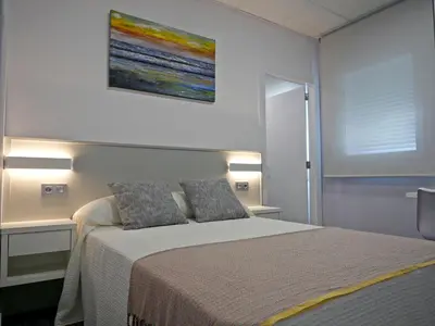 a bedroom with a bed and a painting on the wall at Siaba Pensión Boutique in Sigüeiro