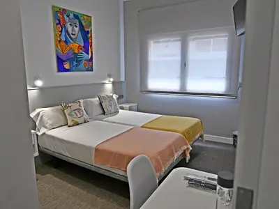 a small room with a bed and a window at Siaba Pensión Boutique in Sigüeiro