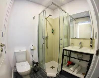 a bathroom with a shower and a toilet and a sink at Siaba Pensión Boutique in Sigüeiro