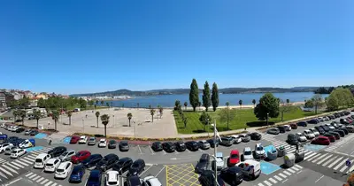 a parking lot filled with lots of parked cars at Apartamento A Tenencia in Sada
