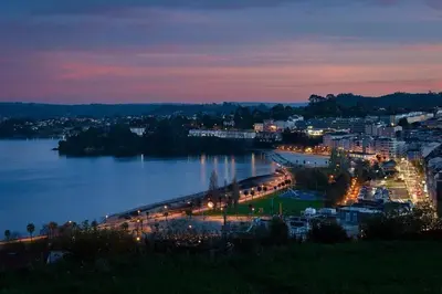 a view of a city with a river at night at Apartamento A Tenencia in Sada