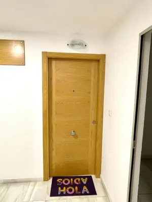 a small bedroom with a bed and a dresser at Apartamento TIERRA in Viveiro