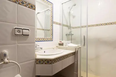 a hallway with a mirror and a chair and a sink at CASA PAZOS-ARBO in Arbo