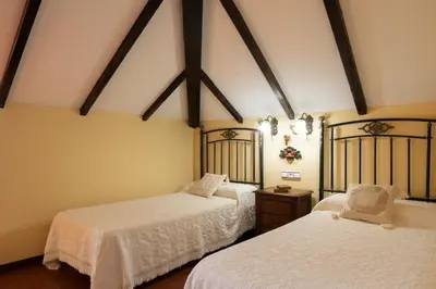 a bedroom with a bed and a chair at CASA PAZOS-ARBO in Arbo