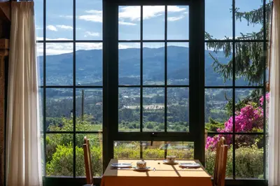 a living room with a large wooden table and chairs at CASA PAZOS-ARBO in Arbo