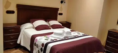 a bedroom with a bed with two towels on it at Casa de Aldea El Boje in Faedo