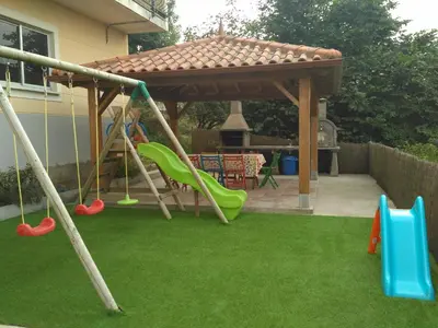 a playground with swings and a gazebo at Casa de Aldea El Boje in Faedo