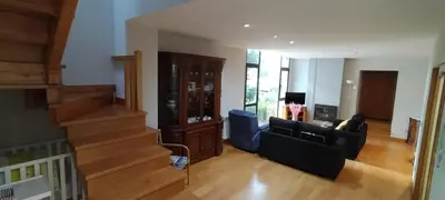 a living room with a couch and a stair case at Casa do Corredor in Chantada
