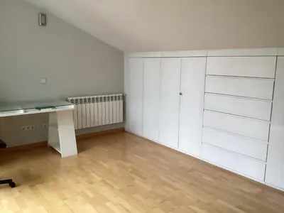 an empty room with white cabinets and a desk at Casa do Corredor in Chantada