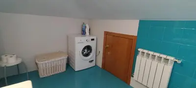 a laundry room with a washing machine and a washer at Casa do Corredor in Chantada