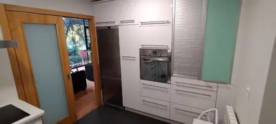 a kitchen with stainless steel appliances and a doorway at Casa do Corredor in Chantada