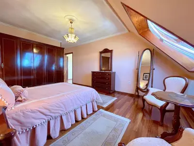 a bedroom with a bed and a table and a mirror at The Cliffs - Milamarina in Viveiro