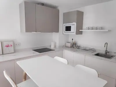a kitchen counter with a coffee maker and a mixer at Apartamentos CANDEA in Lugo