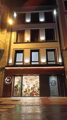 a sign on the door of a building at Apartamentos CANDEA in Lugo