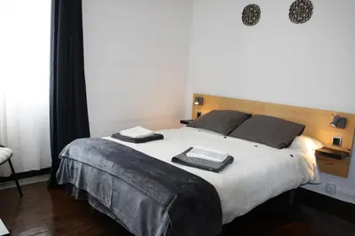 a bedroom with a large bed with two towels on it at APARTAMENTO CÉNTRICO, AMPLIO y LUMINOSO in Guitiriz