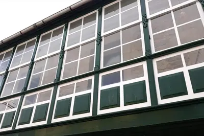 a building with many windows on the side of it at APARTAMENTO CÉNTRICO, AMPLIO y LUMINOSO in Guitiriz