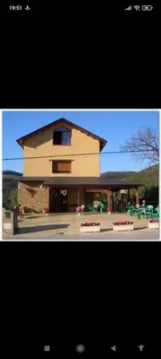 two pictures of a large building with a building at Albergue de peregrinos Santa Marina in Molinaseca