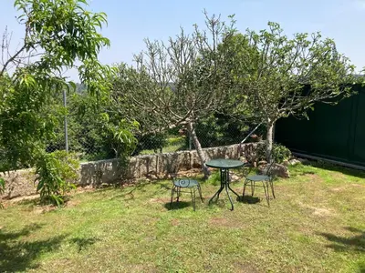 a table and two chairs in a yard at A casa da Ita in Ourense