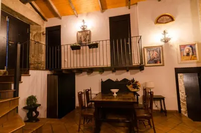 a dining room with a table and a balcony at A casa da Ita in Ourense