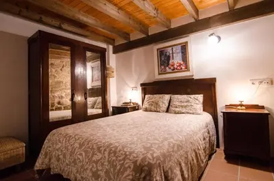 a bedroom with a large bed in a room at A casa da Ita in Ourense