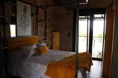 a bedroom with a bed with a canopy bed sidx sidx sidx at CASA VACACIONAL ACIO in Ourense